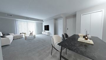 Solon apartment for rent - A modern living room with a black table and white furniture.