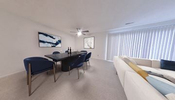 Strongsville apartment for rent - A modern living room with a black dining table and blue chairs.