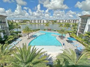 Fort Myers apartment for rent - Heated pool with swim lane, cabanas, sun shelves and WiFi overlooking private lake