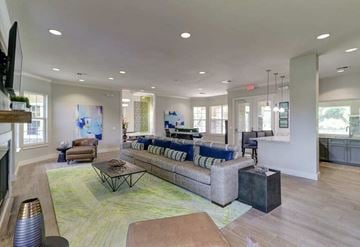 Tampa apartment for rent - A spacious living room with a large sectional sofa and a coffee table.