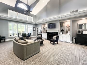 Charlotte apartment for rent - A living room with a grey couch and a television on the wall.