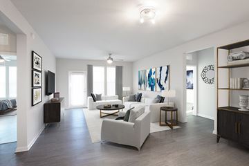 Davenport apartment for rent - A modern living room with a white sofa set and a wooden floor.