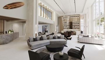 Miami apartment for rent - A modern living room with a large grey sofa and a black coffee table.