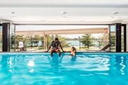 Detroit apartment for rent - A man and a woman are in a swimming pool.
