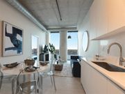 Detroit apartment for rent - A modern kitchen with a dining table set for two.
