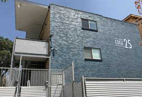 Denver apartment for rent - A modern building with the sign "EDGE 25" on the side.