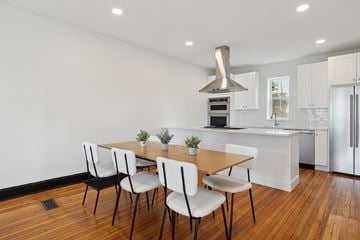Denver apartment for rent - A kitchen with a table and chairs in front of it.