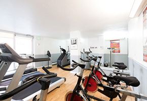 Denver apartment for rent - A gym with treadmills, exercise bikes and other equipment.