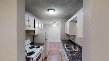 Aurora apartment for rent - A kitchen with a stove top oven and a sink.