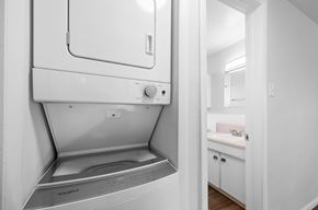 Lakewood apartment for rent - A white washing machine is in a small laundry room.