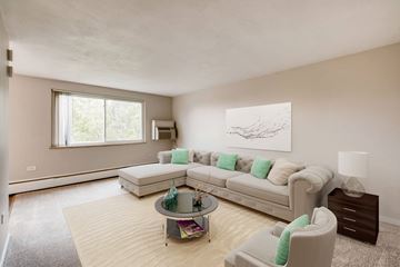 Denver apartment for rent - A living room with a white couch and a coffee table.