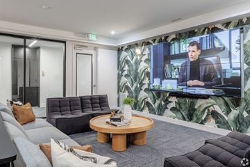 Denver apartment for rent - A man is on a television screen in a living room.