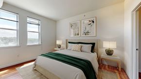 Englewood apartment for rent - A bedroom with a large bed and two lamps.