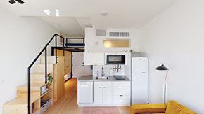 Denver apartment for rent - A kitchen with white cabinets and a white fridge.