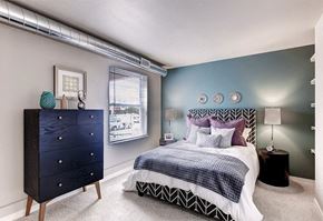 Denver apartment for rent - A bedroom with a bed, nightstand, and a dresser.