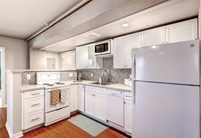 Denver apartment for rent - A white kitchen with a refrigerator on the right.