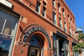 Denver apartment for rent - Exterior brick facade of The Burlington apartments showing  main entry door.