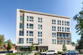Denver apartment for rent - A modern building with a clear blue sky in the background.