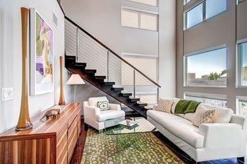 Denver apartment for rent - A living room with a white couch and a glass coffee table.