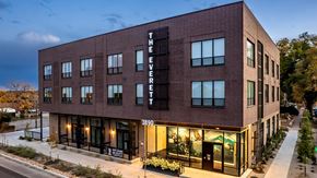 Denver apartment for rent - The Everett building is a modern structure with a dark facade and large windows.
