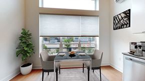 Denver apartment for rent - A dining room with a table set for two and a view of the city.