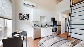 Denver apartment for rent - A modern kitchen with a dining table and chairs.