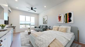 Denver apartment for rent - A bedroom with a large bed and a painting on the wall.