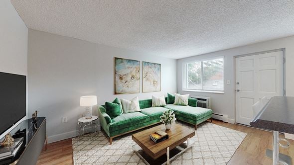 Denver apartment for rent - A living room with a green couch and a painting on the wall.