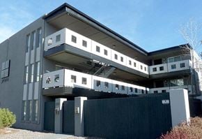 Denver apartment for rent - A modern building with a flat roof and a balcony on the second floor.