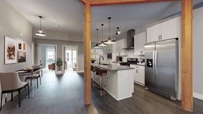 Denver apartment for rent - A modern kitchen with a dining table and chairs.