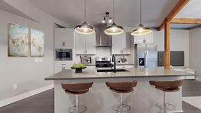Denver apartment for rent - A modern kitchen with a bar stool and a painting on the wall.