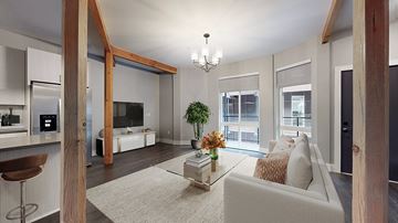 Denver apartment for rent - A modern living room with a white couch and a coffee table.