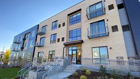 Denver apartment for rent - The image shows a modern building with a glass entrance and a sign that reads "Signalmen."