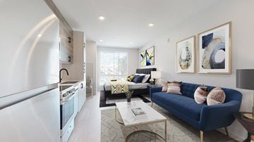 Denver apartment for rent - A modern living room with a blue couch and a coffee table.
