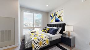 Denver apartment for rent - A bedroom with a large bed and a painting on the wall.