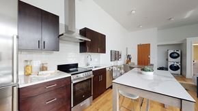 Denver apartment for rent - A modern kitchen with dark wood cabinets and stainless steel appliances.