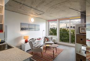 Denver apartment for rent - A modern kitchen with a dining table and chairs.