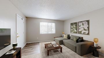 Leadville apartment for rent - A living room with a grey couch, a coffee table, and a painting on the wall.