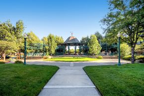 Arvada apartment for rent - A gazebo is surrounded by trees in a park.