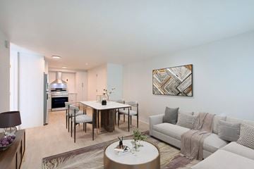 Denver apartment for rent - A modern living room with a white couch and a coffee table in the center.