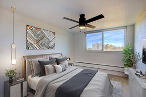 Denver apartment for rent - Modern bedroom with neutral bedding and ceiling fan at Belle on the Park Apartments, Colorado