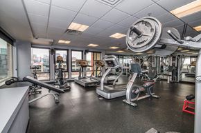 Denver apartment for rent - A gym with a variety of equipment including treadmills, weights, and exercise machines.