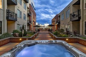 Denver apartment for rent - A hot tub in the middle of a courtyard surrounded by buildings.