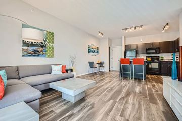 Fort Collins apartment for rent - A modern living room with a grey sofa and a coffee table.