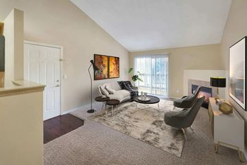 Aurora apartment for rent - A living room with a grey rug and a grey chair.