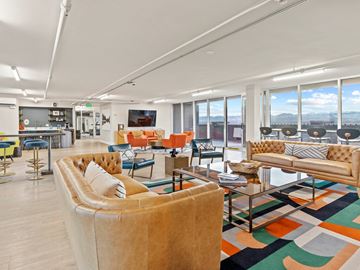 Denver apartment for rent - A living room with a large couch and a coffee table.