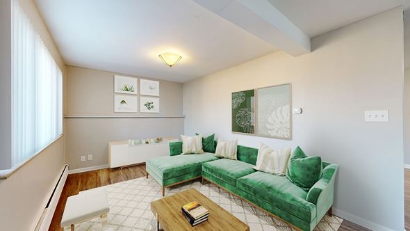 Lakewood apartment for rent - A living room with a green couch and a coffee table.