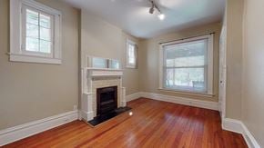 Denver apartment for rent - A room with a fireplace and wooden floors.