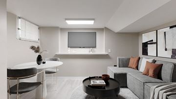 Denver apartment for rent - A modern living room with a grey sofa and a black coffee table.
