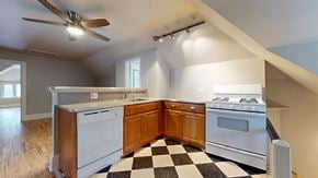 Denver apartment for rent - A kitchen with a checkered floor and a stove top oven.